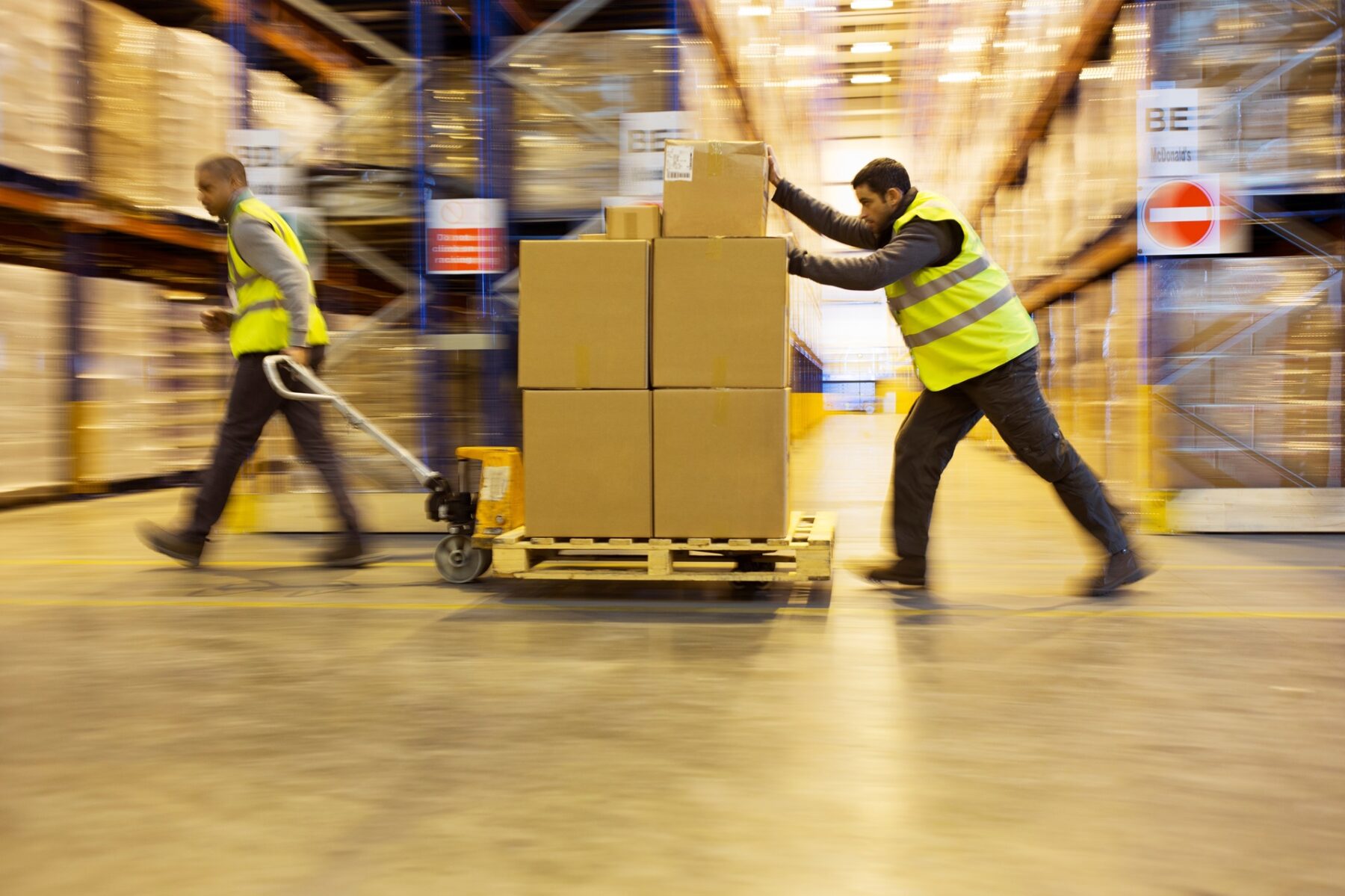 Workers,Carting,Boxes,In,Warehouse