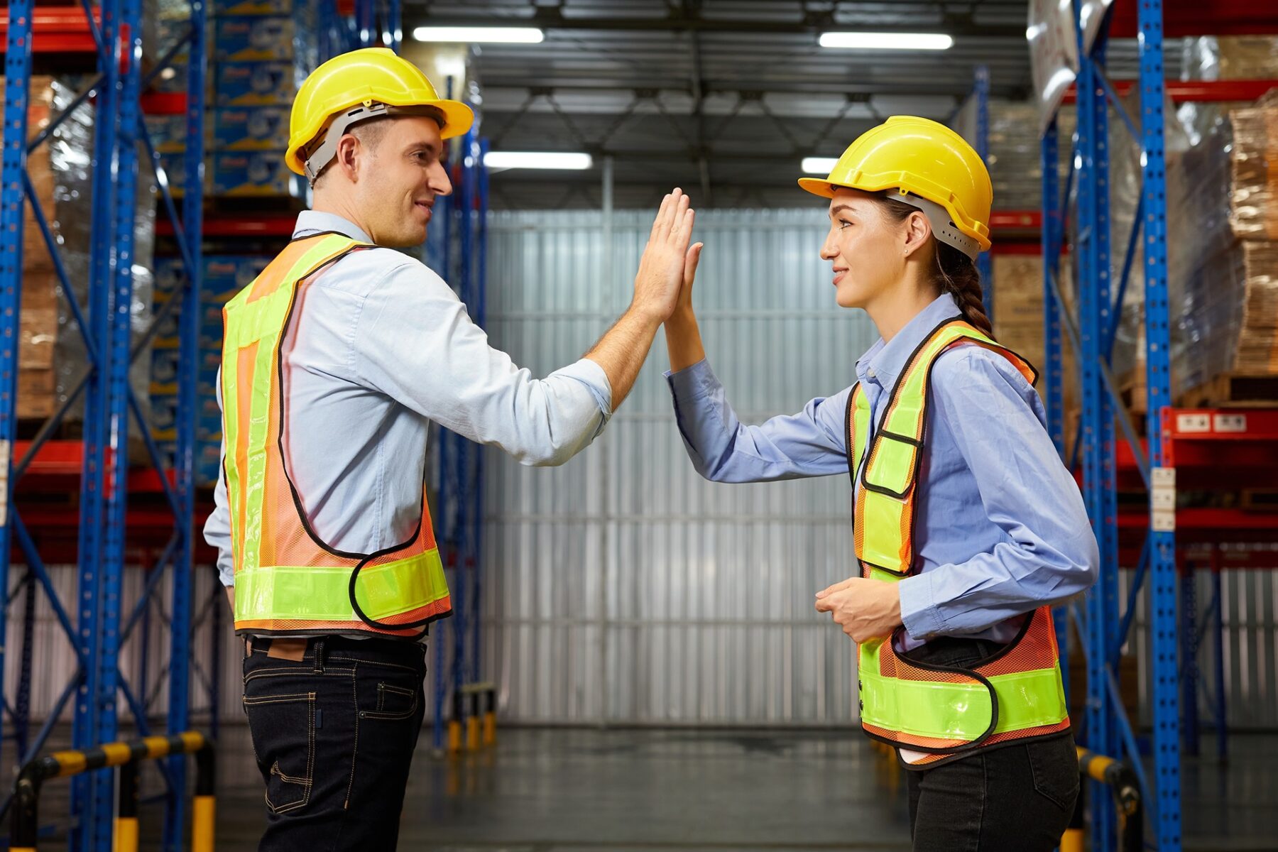 Factory,Workers,Giving,High,Five,Pose,In,The,Warehouse,Storage